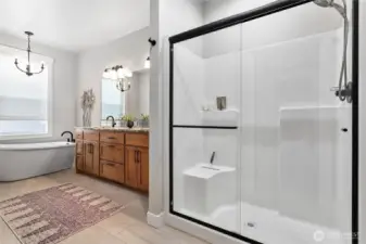 Great size walk-in shower and a large free-standing tub w/large window complete this dreamy ensuite bathroom