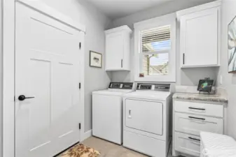 Extra large utility room w/cabinets & closet (to left of pic), plus nook for bench/coats. Speed Queen W/D included!
