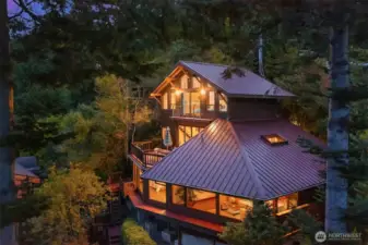 This drone shot captures the west side of the home which faces the sounds. All the rooms in this house have stunning views.