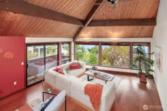 The sunken living room is very large but somehow the wood vaulted ceilings keep things feeling cozy.