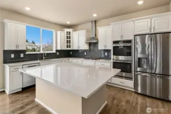 Large island seats 6-7 bar stools easily.