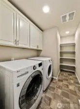Large laundry room with plenty of storage.