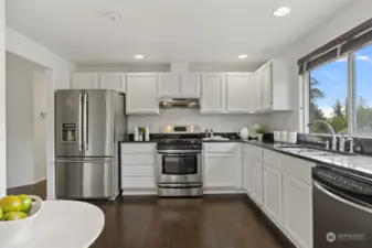 Refreshed cabinetry and stainless steel appliances give the space a chic, modern look.