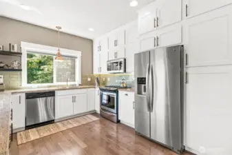Stunning kitchen overlooks the private backyard.