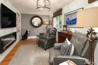 The attached seating area to the garage is a perfect place to hang out. Complete with a TV and electric fireplace for heat.