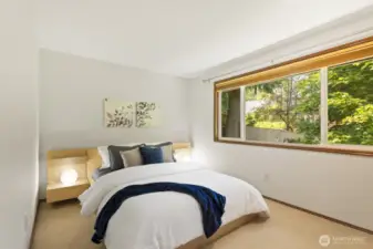 Second upstairs bedroom, looking out to serene treed views.