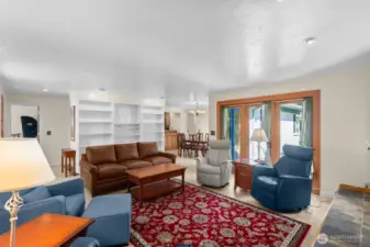 From this corner you can see the wall of bookshelves, the connection to the dining and kitchen area, and the way the french/atrium doors bring in the natural light!