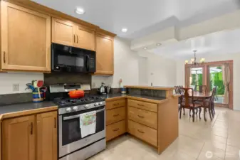 Recessed lighting ensure a bright kitchen for cooking and sharing, while the bar counter offers a space to visit and connect.