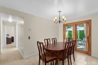 Not to be over-highlighted, the glass atrium door here brings in the beauty and light of nature to the kitchen and dining room, and creates a wonderful flow to the outdoors. The hallway on the left continues to the bedrooms...