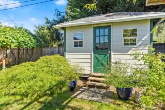 Adorable shed doubles as delightful view and convenient storage!