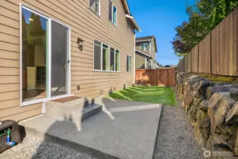 Patio area in the back with artificial turf. No mowing