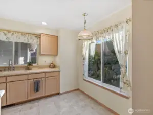 View of the kitchen dining space from the open concept dining room. Enjoy your sipping your morning coffee while enjoying the view of the yard.