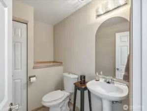 Main floor powder room with linen closet