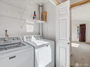 Laundry space is located in the hallway just outside the primary suite