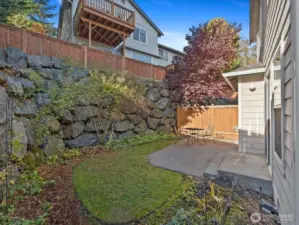 Back  yard & Patio. Plant life includes Hydrangea, Mr Lincoln Rose, Graham Thomas Rose & a Mock Orange Tree. All lovingly planted & care for my the current owner.