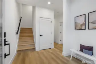 Foyer with vaulted ceiling and large coat & storage closet.
