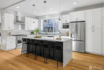 Spacious kitchen with island and bar seating.  Gas range and high end appliances.