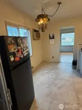 The dining area is to the left of the kitchen.  The chandelier is original vintage to match the home (very unique).