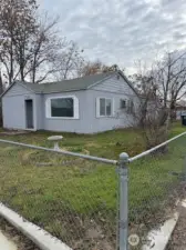 This fully fenced front and back is just waiting for a new owner's vision to add to its curb appeal.  Plenty of room for a garden too