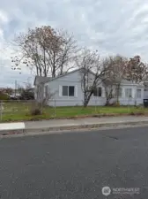 Another view of the West side of the home.  Notice the mature trees and lawn space.