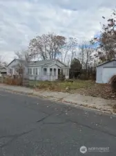 The back of the home offers a direct access to the garage/shop.  The driveway into the garage also has a wide piece of the fence that can be closed.