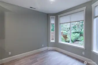 Open dining area off kitchen with bay window and door leading to back yard patio.