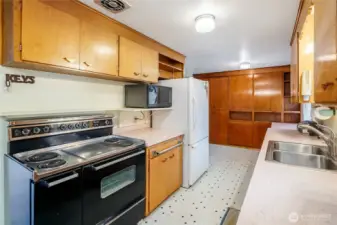 Original real wood cabinets with unique electric stove/range.
