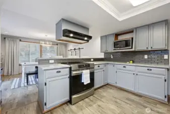 this kitchen has lots of cabinets and counter tops for storage, cooking or hosting.