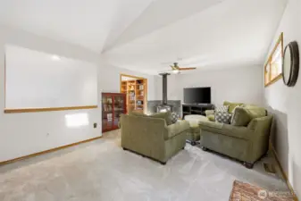 coming up the stairs you walk into the open bonus room with a wood burning fire place.