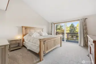 walking down the hall you walk into the main bedroom with a walk in closet with an en suite and a private balcony overlooking the lake