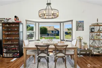 Dining area is showcased with bay windows