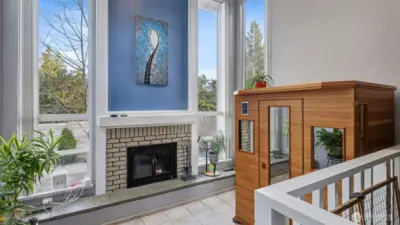 Endless possibilities with this sun-filled flex space with fireplace and soaring windows