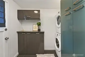 Laundry area in the mud room. Chic wall paper adds character!