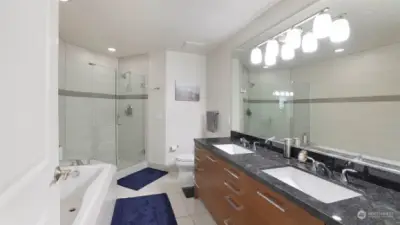 Tastefully designed en-suite with tiled floors, soaking tub, dual sinks and more of the high-end Padini cabinetry.