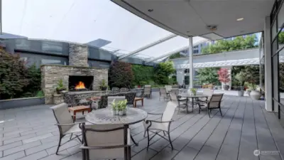 Outdoor patio features a large fireplace, ample seating space & multiple BBQ's.