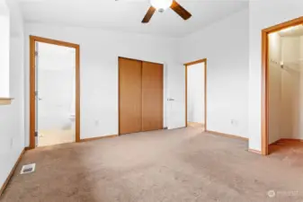 Primary bedroom with 2 closets. Private bathroom to the right, main closet next to it and a spacious walk-in closet to the right in the picture