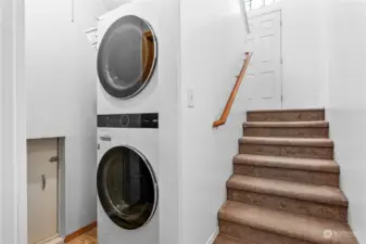 Shared laundry space with 2 doors that can be closed off between living spaces. Also a large/dry storage area under the home through the crawl space door pictured