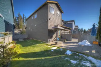 Fully fenced (stained recently) yard with extended pavers for chairs, firepit, or outdoor dining.