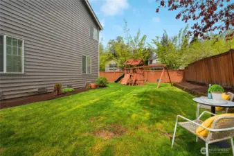 Oversized backyard has plenty of space to play or garden.