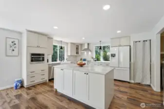 New quartz kitchen includes new lighting and flooring.