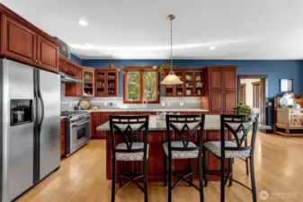 Cooks kitchen! Dacor range, stainless Frigidaire, glass fronted upper cabinets, pull out drawers throughout, expansive granite island and counters, glass subway tile