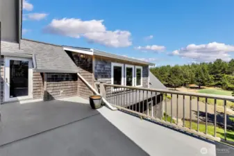 Upstairs east facing deck, overlooking the patio. Sheltered from NW breezes.