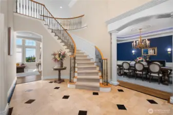 Grand entry with Office/Library to the left and elegant dining to the right.