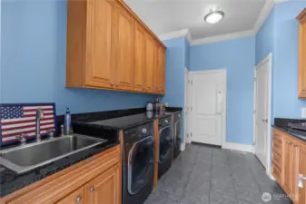 One of the two laundry areas. Featuring a total of 2 washers and 3 dryers!