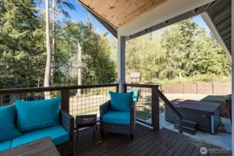 Covered deck. Large patio with hot tub