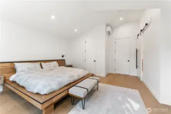 Primary bedroom High vaulted ceilings throughout the top floor; for perspective the entry door in the middle of the frame is 8'.