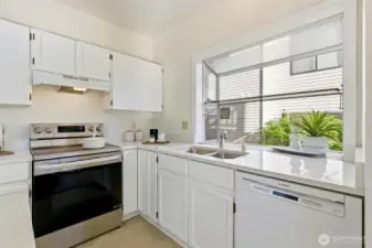 Refreshed kitchen featuring sleek quartz countertops and updated cabinetry.