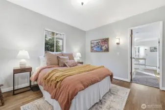 Here is one of the two additional bedrooms in the main portion of the home. The open doorway leases to a full bathroom and another bedroom.