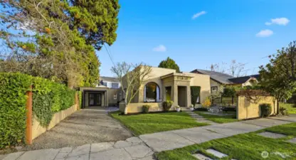 Here you can observe the driveway along the side of the home… your tandem parking spaces. The primary suite was a garage several years ago. A carport could easily be added.