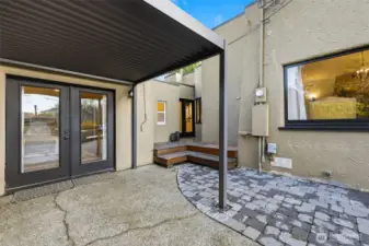 The overhead cover can be adjusted to allow for sunlight, or to protect against the rain. The door seen at top of the deck leads into the hallway outside the kitchen.
